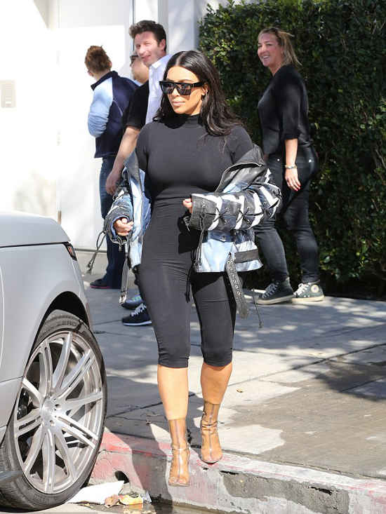 Kim Kardashian news as she wears Yeezy perspex boots and spray painted biker jacket - AngryGIF